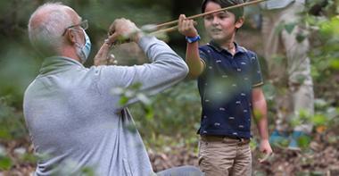 Photographie d'une initiation d'un enfant au tir au propulseur